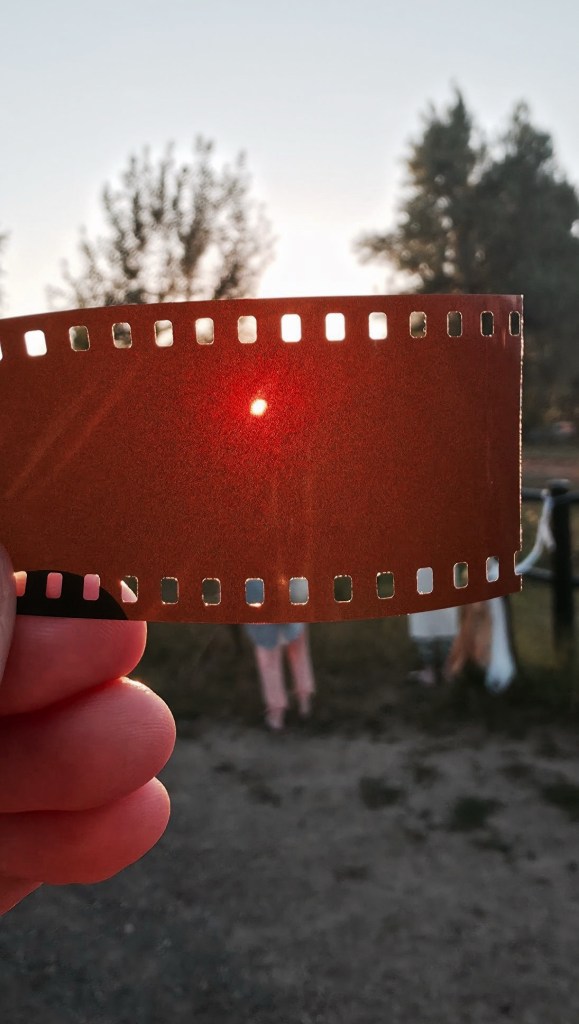 Widok zaćmienia słońca przez kliszę fotograficzną 
